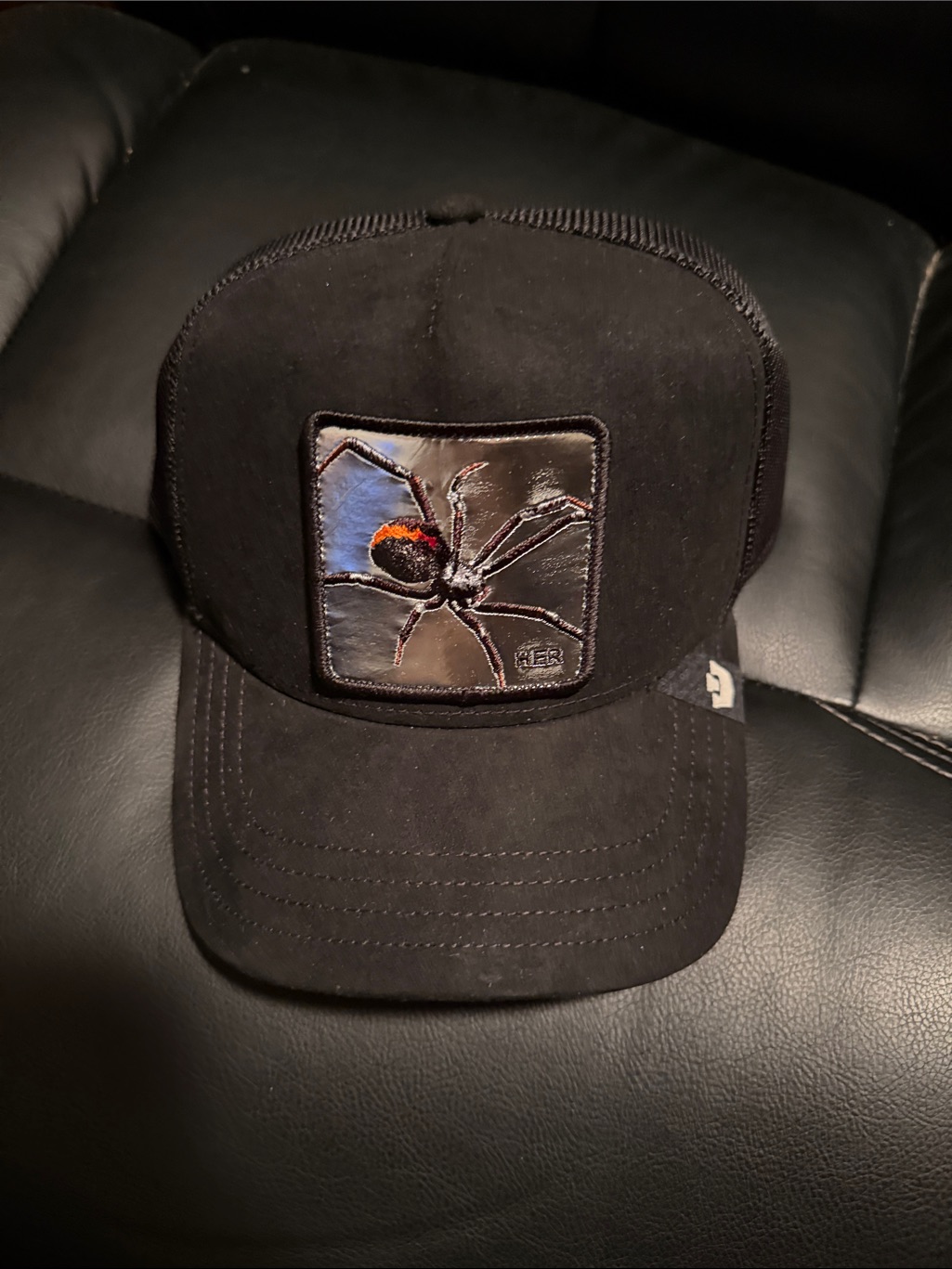 Black Trucker Hat With Embroidered "Her" Spider Patch